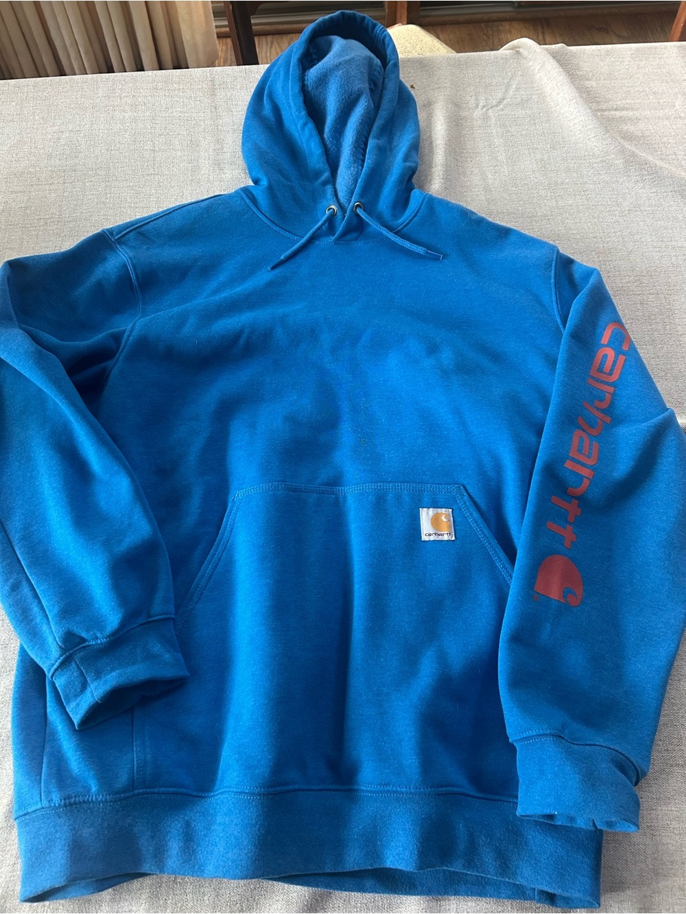 Carhartt Blue Hooded Sweatshirt with Red Sleeve Logo